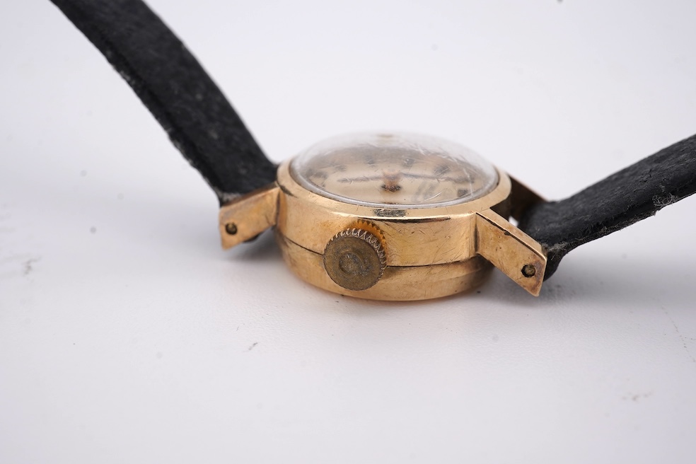 A lady's 9ct gold Omega Automatic wrist watch, on an associated leather strap, gross weight 11 grams. Condition - poor to fair